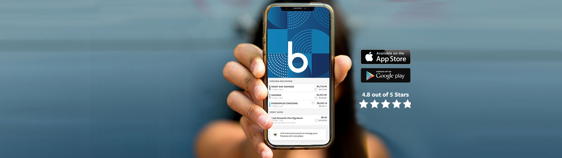 Person holding up a phone displaying BCU app